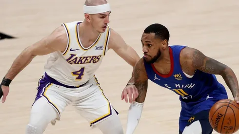 Monte Morris (right) of the Denver Nuggets is guarded by Alex Caruso (left) of the Los Angeles Lakers. (Getty)
