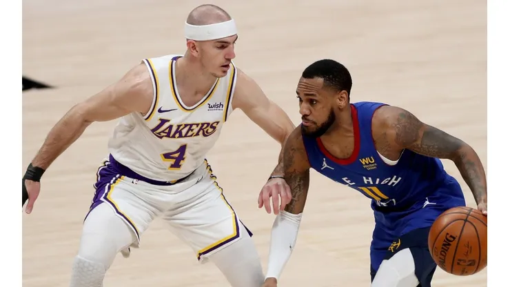 Monte Morris (right) of the Denver Nuggets is guarded by Alex Caruso (left) of the Los Angeles Lakers. (Getty)