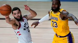 Fred VanVleet (left) of the Toronto Raptors passes the ball against LeBron James (right) of the Los Angeles Lakers. (Getty)