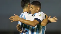 Juan Cáceres (right) celebrates with Maximiliano Lovera (left) of of Racing Club. (Getty)