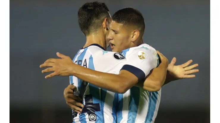 Juan Cáceres (right) celebrates with Maximiliano Lovera (left) of of Racing Club. (Getty)
