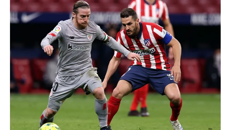 Iker Muniain of Athletic Club (left) is challenged by Koke of Atletico Madrid (right). (Getty)