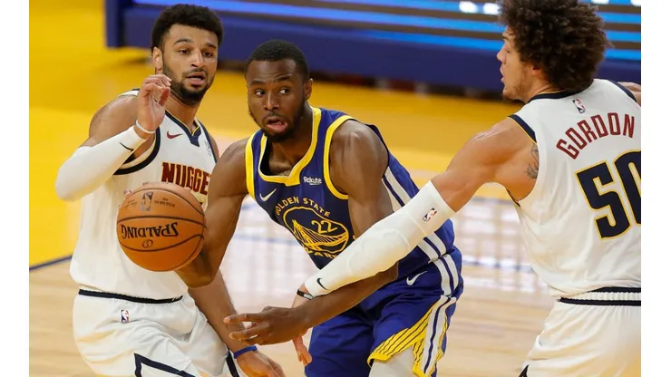 Andrew Wiggins (center) of the Golden State Warriors is guarded by Aaron Gordon (right) and Jamal Murray (left) of the Denver Nuggets. (Getty)