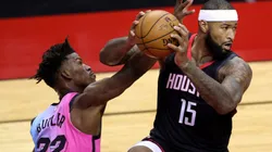 DeMarcus Cousins (right) of the Houston Rockets controls the ball under pressure from Jimmy Butler (left) of the Miami Heat. (Getty)