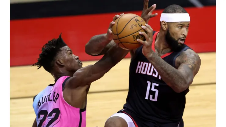 DeMarcus Cousins (right) of the Houston Rockets controls the ball under pressure from Jimmy Butler (left) of the Miami Heat. (Getty)