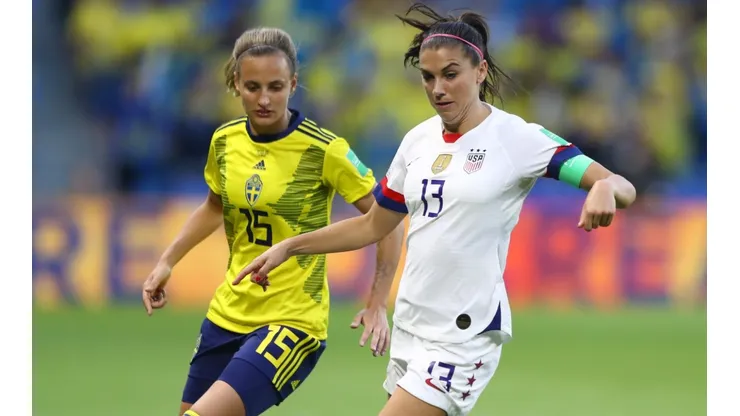 Alex Morgan of the USA (right) battles for possession with Nathalie Bjorn of Sweden (left).
