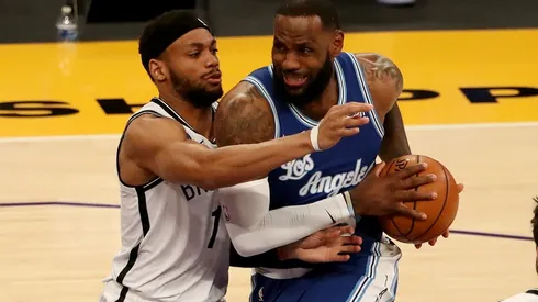 LeBron James (right) of the Los Angeles Lakers drives to the basket against Bruce Brown (left) of the Brooklyn Nets.
