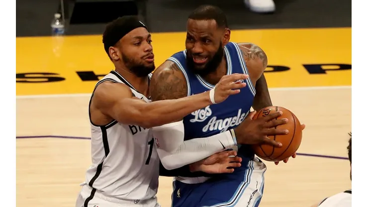 LeBron James (right) of the Los Angeles Lakers drives to the basket against Bruce Brown (left) of the Brooklyn Nets.