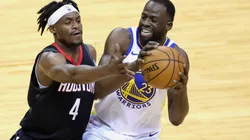 Draymond Green (right) of the Golden State Warriors controls the ball against Danuel House Jr. (left) of the Houston Rockets.