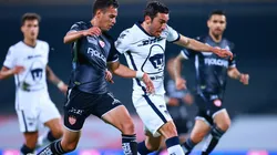 Raul Sandoval (left) of Necaxa struggles for the ball against Juan Vigon (right) of Pumas UNAM.
