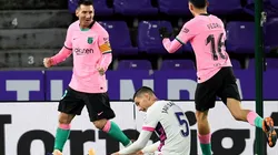 Lionel Messi (left) and Pedri (right) of Barcelona celebrate as Javier Sanchez of Real Valladolid (center) reacts.