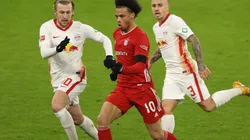 Leroy Sane of Bayern (center) runs with the ball against Leipzig.