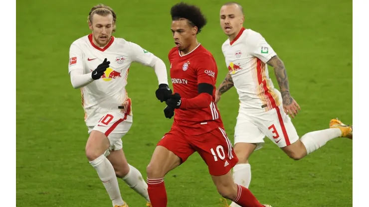 Leroy Sane of Bayern (center) runs with the ball against Leipzig.