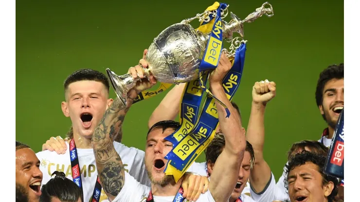 Leeds United players lift the 2019-20 EFL Championship trophy.