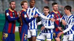 Barcelona players and Real Sociedad players compete for a corner kick during the Supercopa de Espana Semi-Final