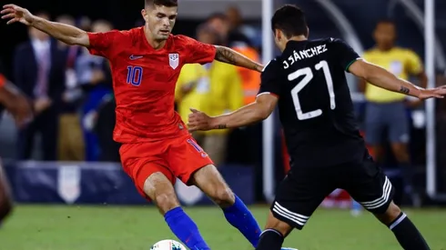 Christian Pulisic #10 of the United States drives by Jorge Sanchez #21 of Mexico (Getty)