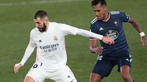 Karim Benzema of Real Madrid (left) is put under pressure by Renato Tapia of Celta Vigo (right).
