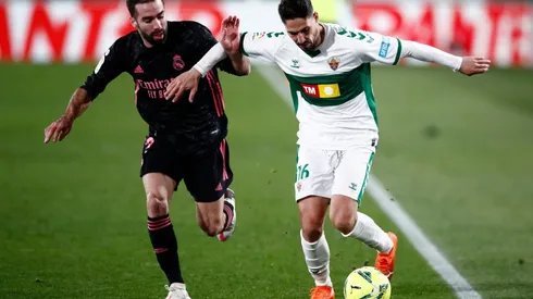 Fidel of Elche (right) battles for possession with Dani Carvajal of Real Madrid (left). (Getty)