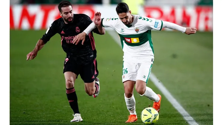 Fidel of Elche (right) battles for possession with Dani Carvajal of Real Madrid (left). (Getty)