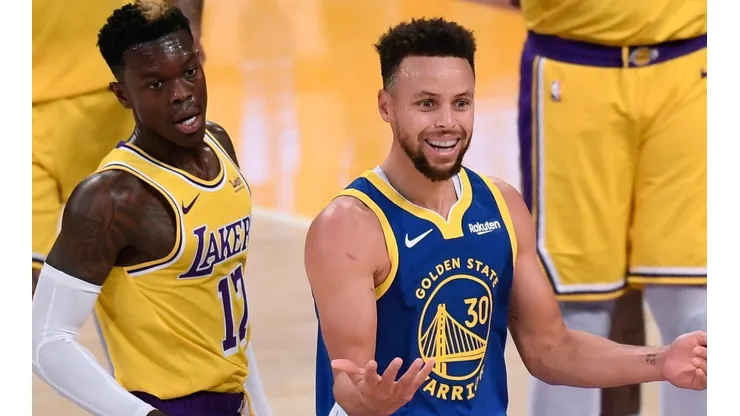 Stephen Curry (right) of the Golden State Warriors reacts after a foul on Dennis Schroder (left) of the Los Angeles Lakers. (Getty)
