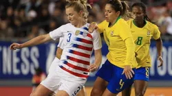 Samantha Mewis (left) of the USA looks to pass the ball over Erika (right) of Brazil. (Getty)