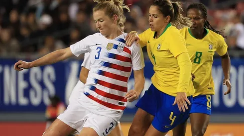 Samantha Mewis (left) of the USA looks to pass the ball over Erika (right) of Brazil. (Getty)