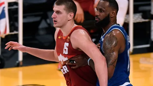 Nikola Jokic (left) of the Denver Nuggets is guarded by LeBron James (right) of the Los Angeles Lakers. (Getty)