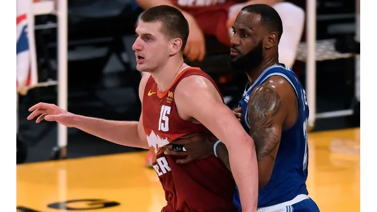 Nikola Jokic (left) of the Denver Nuggets is guarded by LeBron James (right) of the Los Angeles Lakers. (Getty)