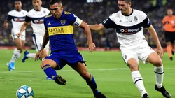 Carlos Tevez of Boca Juniors (left) drives the ball against Maximiliano Coronel of Gimnasia (Getty).