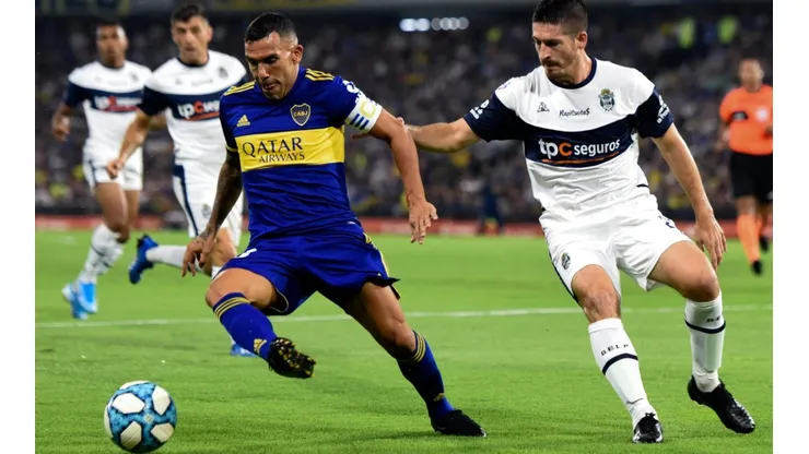 Carlos Tevez of Boca Juniors (left) drives the ball against Maximiliano Coronel of Gimnasia (Getty).