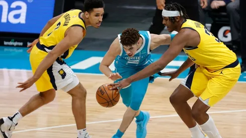 Malcolm Brogdon and Myles Turner guarding LaMelo Ball. (Getty)