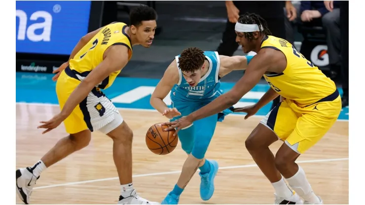 Malcolm Brogdon and Myles Turner guarding LaMelo Ball. (Getty)