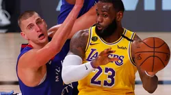 LeBron James (right) of the Los Angeles Lakers passes against Nikola Jokic (left) of the Denver Nuggets. (Getty)