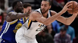 Draymond Green (left) of the Golden State Warriors defends against Rudy Gobert (right) of the Utah Jazz. (Getty)