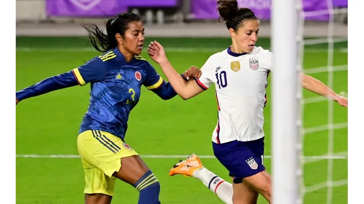 Carli Lloyd (right) of the United States shoots the ball against Sandra Sepulveda (left) of Colombia. (Getty)