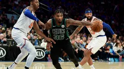 RJ Barrett (left) of the New York Knicks guards Marcus Smart (centre) of the Boston Celtics. (Getty)