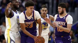 Cameron Johnson (centre) and Tyler Johnson (right) of the Phoenix Suns are guarded by Eric Paschall (left) of the Golden State Warriors. (Getty)
