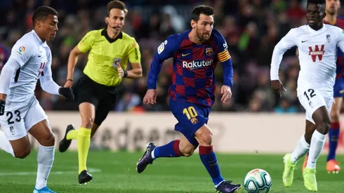Lionel Messi of FC Barcelona (cenre) runs with the ball under pressure from Darwin Machis (left) and Ramon Azeez (right) of Granada CF. (Getty)