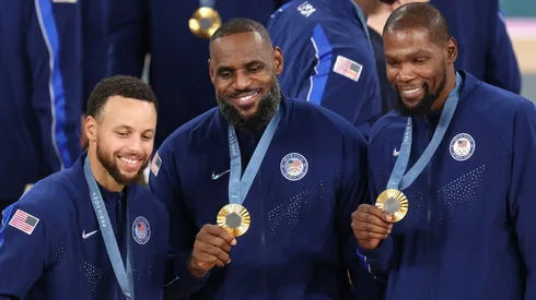 Stephen Curry, LeBron James, and Kevin Durant of Team United States pose for a photo during the Men's basketball medal ceremony on day fifteen of the Olympic Games Paris 2024 at Bercy Arena on August 10, 2024 in Paris, France.