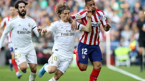 Luka Modric (centre) and Isco (left) of Real Madrid battle for possession with Renan Lodi of Atletico Madrid (right). (Getty)