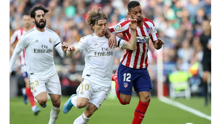 Luka Modric (centre) and Isco (left) of Real Madrid battle for possession with Renan Lodi of Atletico Madrid (right). (Getty)