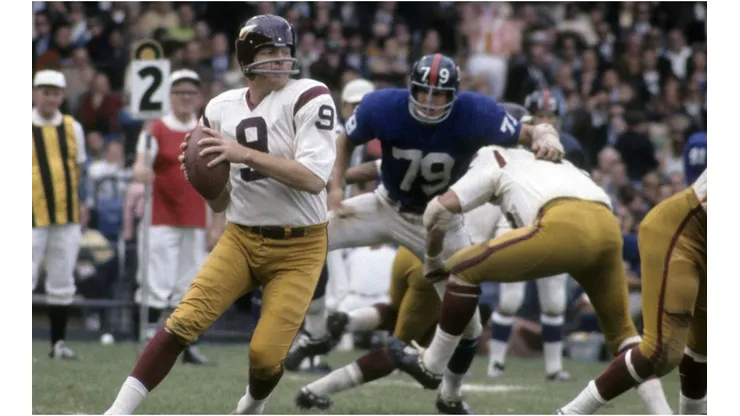 Sonny Jurgensen of the Washington Redskins trying to avoid a sack. (Getty)