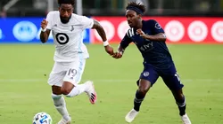 Romain Metanire of Minnesota United (left) runs the ball past Gerso of Sporting Kansas City (Getty).
