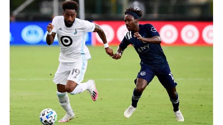 Romain Metanire of Minnesota United (left) runs the ball past Gerso of Sporting Kansas City (Getty).