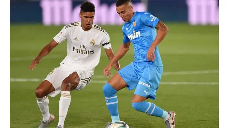 Rodrigo Moreno of Valencia CF (right) is challenged for the ball by Raphael Varane of Real Madrid (left). (Getty)
