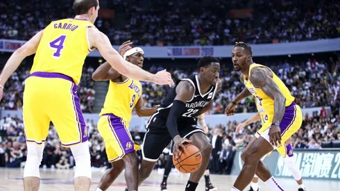 Alex Caruso, Rajon Rondo, and Dwight Howard guarding Nets' Caris LeVert. (Getty)