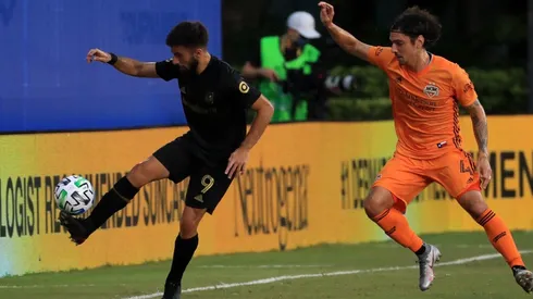 Diego Rossi of Los Angeles FC (left) fights for the ball with Zarek Valentin of Houston Dynamo (Getty).