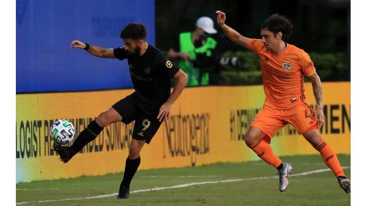 Diego Rossi of Los Angeles FC (left) fights for the ball with Zarek Valentin of Houston Dynamo (Getty).