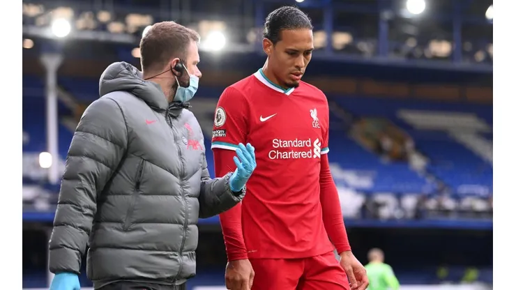 Liverpool's Virgil van Dijk leaves the game with an injury after a challenge by Everton goalkeeper Jordan Pickford. (Getty)