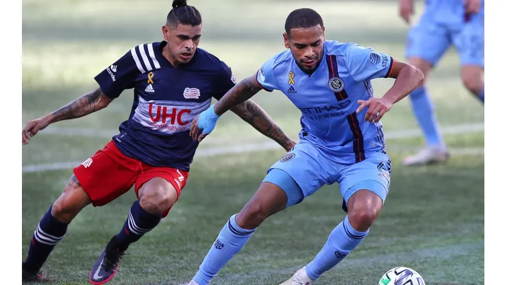 New England Revolution player Gustavo Bou (left), chases the ball with New York's Alexander Callens (right). (Getty)